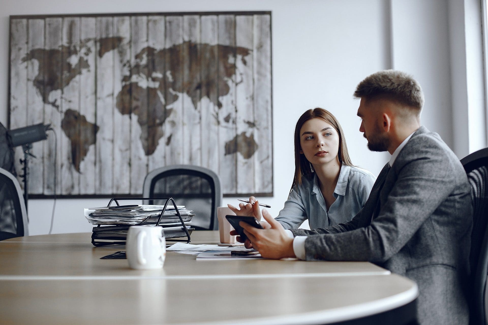 man-uses-tablet-business-partners-business-meeting-people-are-sitting-table-2
